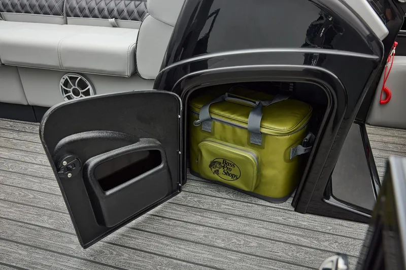 Slide: The Image of Manufacturer Provided Image: Open storage compartment on 2026 Ranger 220FC boat with green Bass Pro Shops cooler. - 24