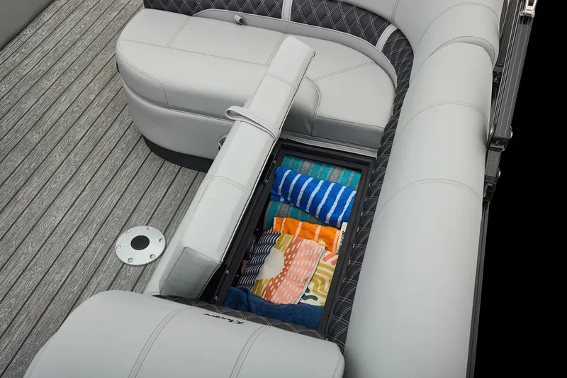Slide: The Image of Manufacturer Provided Image: 2026 Ranger 220FC boat with open storage compartment, revealing colorful towels on deck. - 34