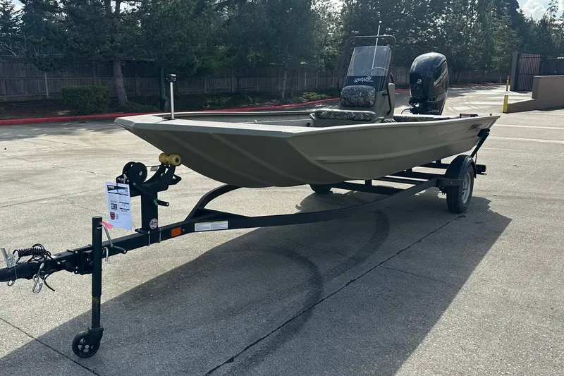 Slide: The Image of 2026 Tracker Grizzly 1860 CC boat on trailer, parked outdoors. - 9