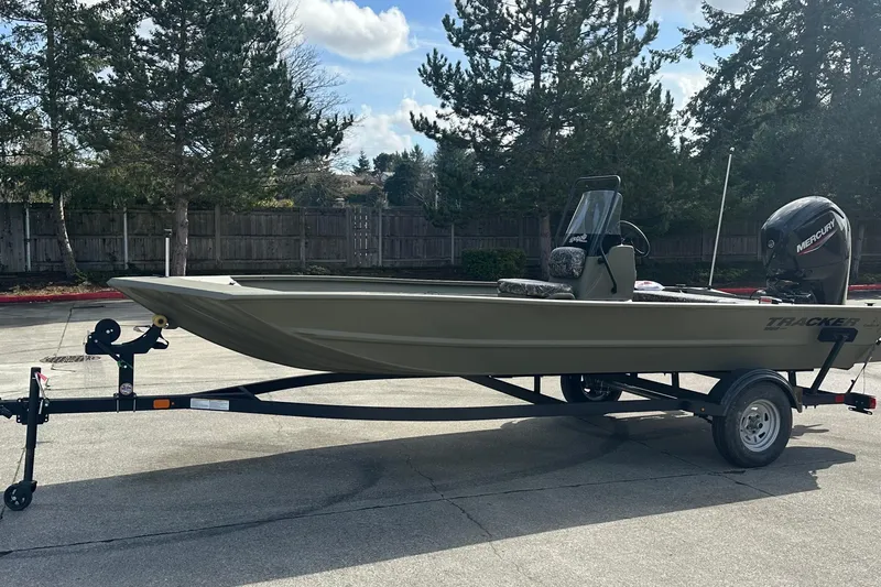 Slide: The Image of 2026 Tracker Grizzly 1860 CC boat on trailer, parked outdoors, with Mercury outboard motor. - 8