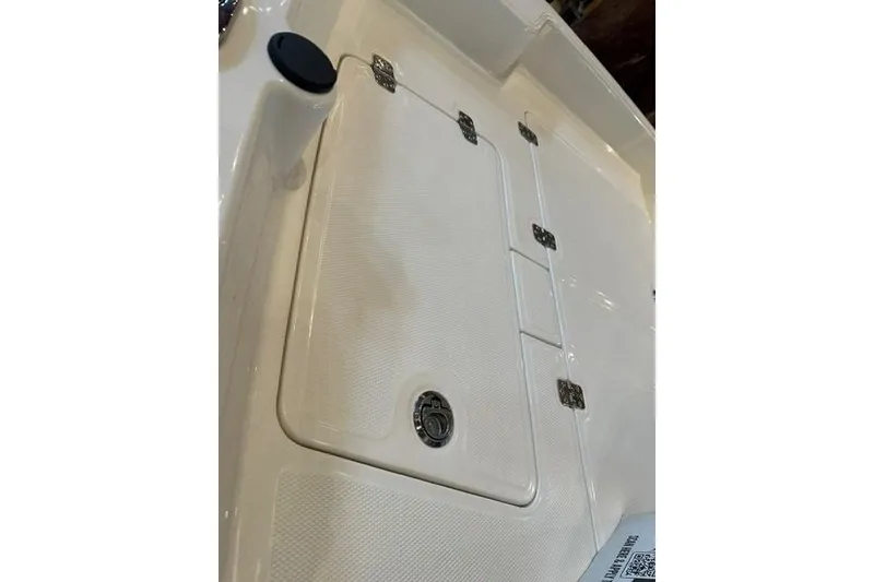 Slide: The Image of 2026 Mako Pro Skiff 15 CC boat hatch with secure latches and sleek design. - 7