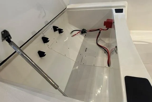 Slide: The Image of 2026 Mako Pro Skiff 15 CC storage compartment with wiring and hydraulic support. - 8