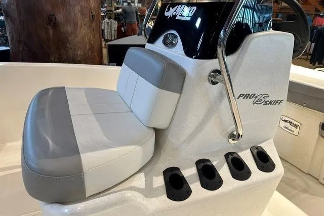 Slide: The Image of 2026 Mako Pro Skiff 15 CC boat seat and console with rod holders. - 6