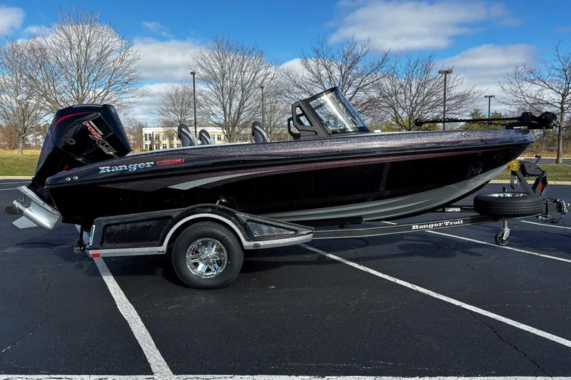 The Image of 2026 Ranger 1880MS boat on trailer in parking lot, clear sky background. - 0