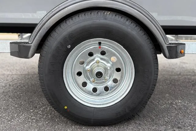 Slide: The Image of Trailer wheel of 2026 Tracker Bass Tracker Classic CC on asphalt surface. - 26