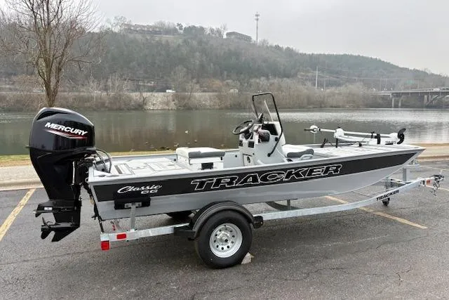 Slide: The Image of 2026 Tracker Bass Tracker Classic CC boat on trailer by a river. - 6