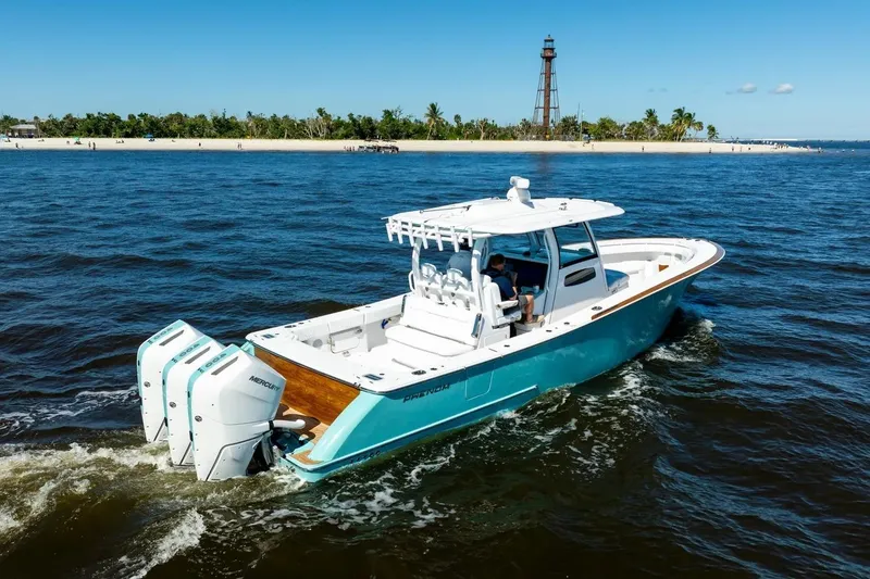 The Image of 2026 Phenom 37 boat cruising near a lighthouse on a sunny day. - 1