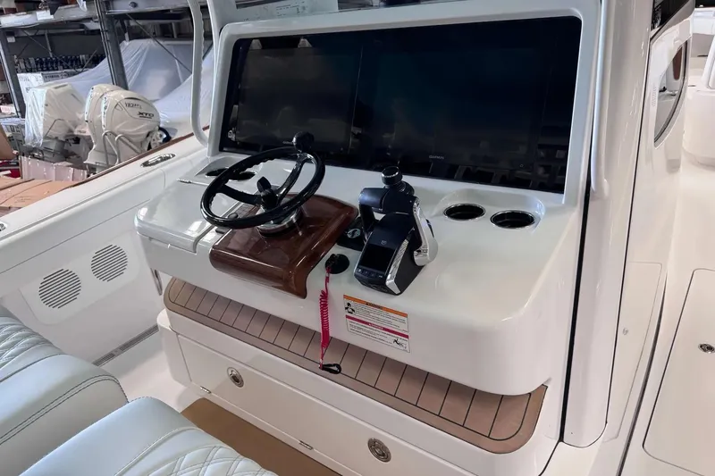 Slide: The Image of Helm of 2026 Phenom 37 boat with steering wheel and control panel. - 4