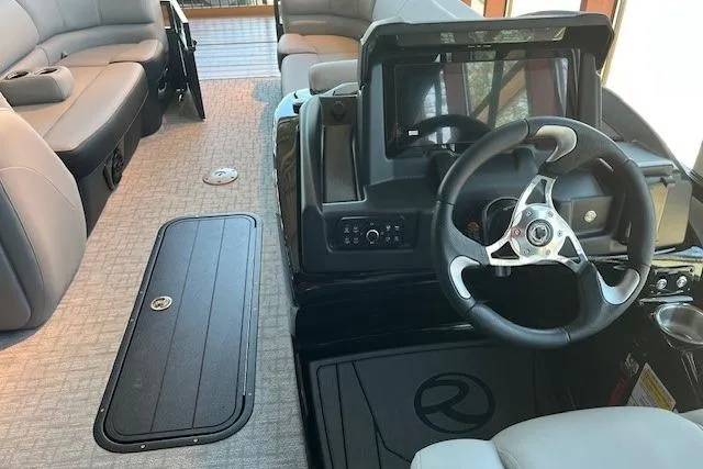 Slide: The Image of 2026 Regency 230 DL boat interior with steering wheel and seating area. - 2