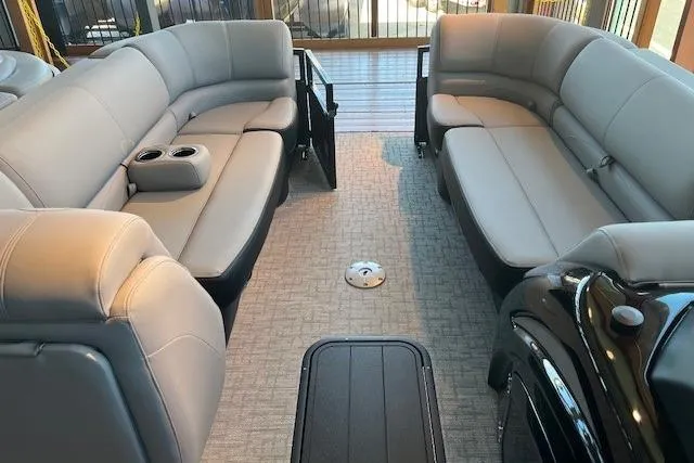 Slide: The Image of Luxurious interior of 2026 Regency 230 DL pontoon boat with plush seating and cup holders. - 3