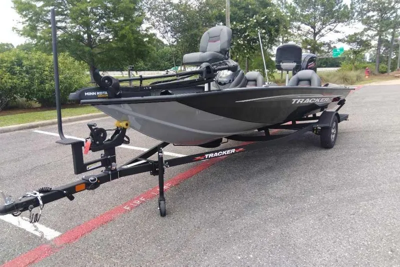 Slide: The Image of 2026 Tracker Pro Team 190 boat on trailer in parking lot, featuring Minn Kota motor. - 2