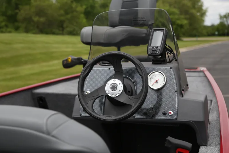 Slide: The Image of 2026 Tracker Bass Tracker Classic XL boat dashboard with steering wheel and navigation display. - 6