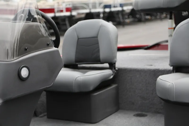 Slide: The Image of 2026 Tracker Bass Tracker Classic XL boat interior with gray seating and steering console. - 7