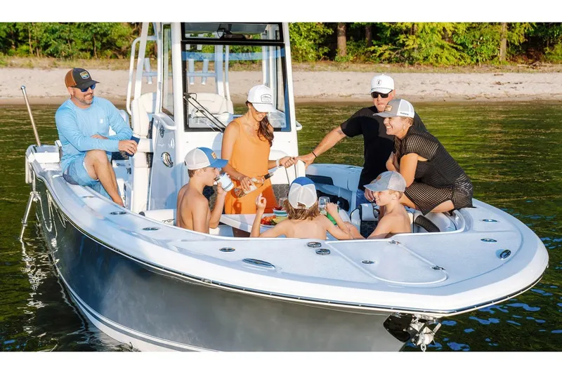 Slide: The Image of 2026 Tidewater 282 CC Adventure boat with dual outboard engines, docked in a marina. - 4