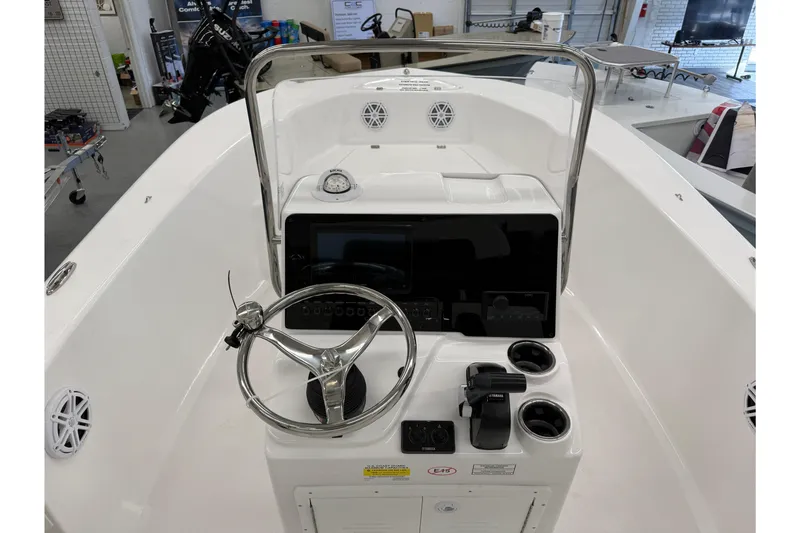 Slide: The Image of 2026 Tidewater 180 CC Adventure boat console with steering wheel and controls. - 10