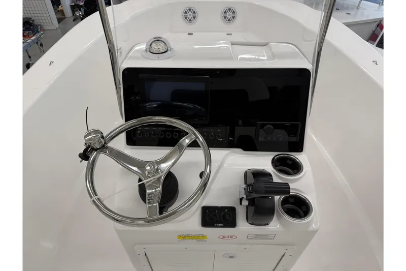 Slide: The Image of 2026 Tidewater 180 CC Adventure boat console with steering wheel and controls. - 11