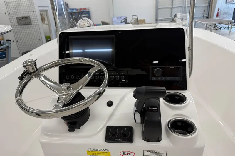 Slide: The Image of 2026 Tidewater 180 CC Adventure boat console with steering wheel and Yamaha controls. - 4