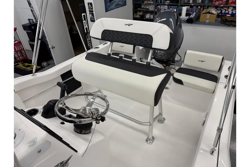 Slide: The Image of 2026 Tidewater 180 CC Adventure boat interior with steering wheel and seating. - 8