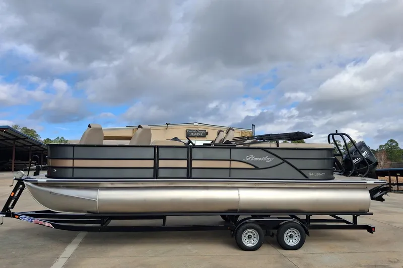 The Image of 2026 Bentley Pontoons Legacy 240 DL Navigator on trailer under cloudy sky. - 1