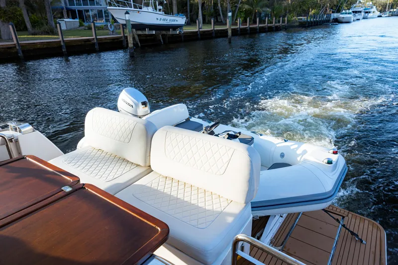 Slide: The Image of 2013 Bavaria Virtess 420 Fly yacht with white seating and Honda outboard motor. - 12