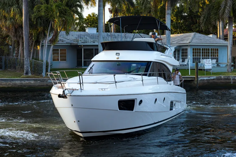 Slide: The Image of 2013 Bavaria Virtess 420 Fly yacht cruising near waterfront homes. - 6