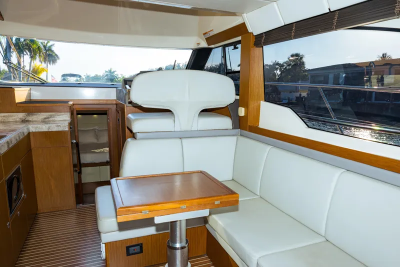 Slide: The Image of Interior of 2013 Bavaria Virtess 420 Fly yacht with modern seating and wooden accents. - 9