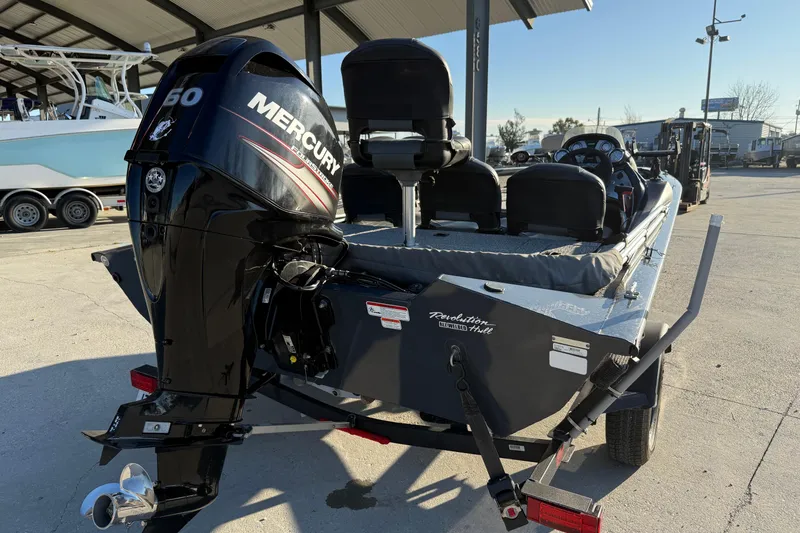 Slide: The Image of 2020 Tracker Pro Team 175 TF boat with Mercury 60 engine, parked under a canopy. - 3