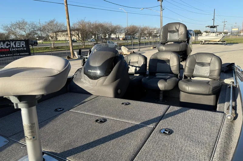 Slide: The Image of 2020 Tracker Pro Team 175 TF fishing boat with seating and console, parked outdoors. - 7