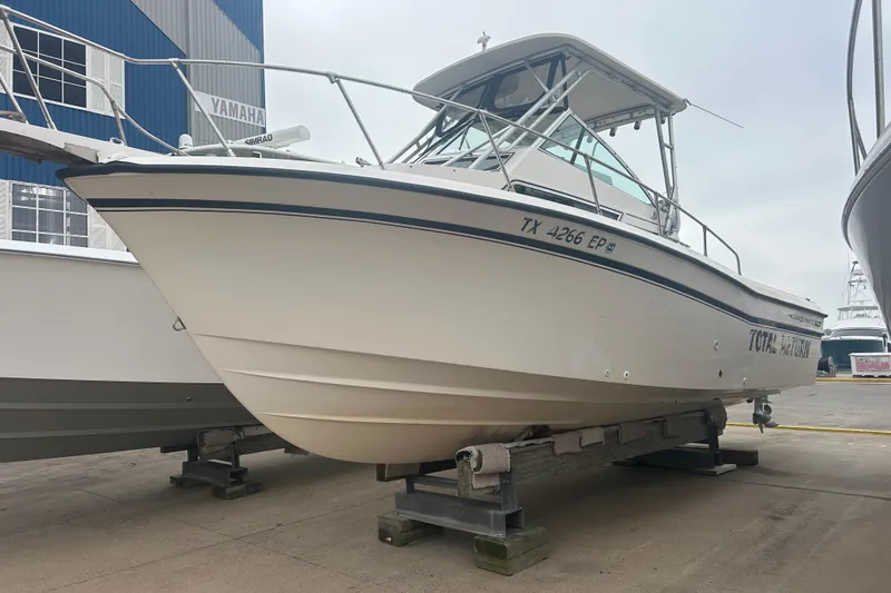 The Image of 1992 Grady-White Sailfish 252 boat on display, docked on a platform. - 0