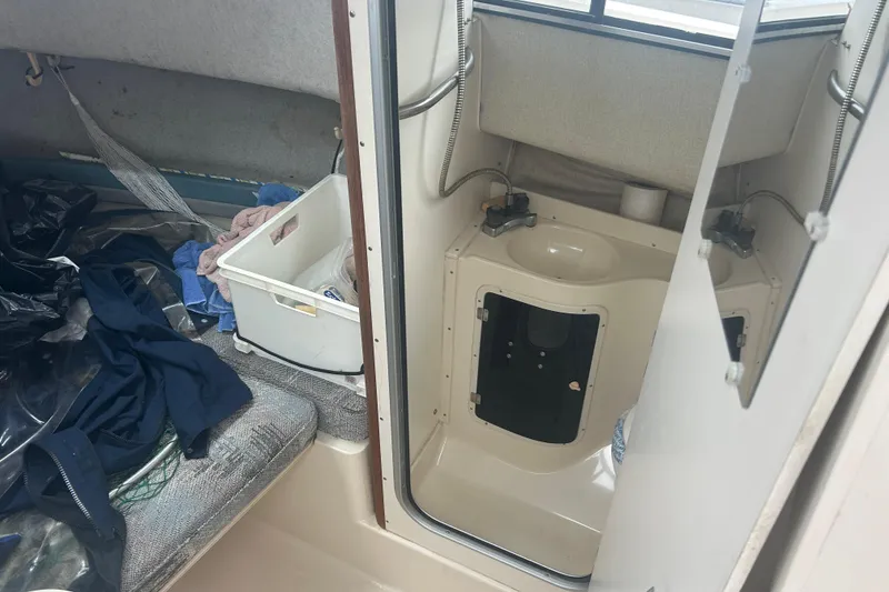 Slide: The Image of Interior of 1992 Grady-White Sailfish 252 boat with sink and storage area. - 10