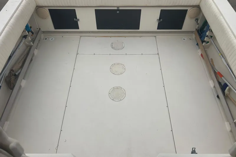 Slide: The Image of 1992 Grady-White Sailfish 252 boat interior with spacious deck and storage compartments. - 12