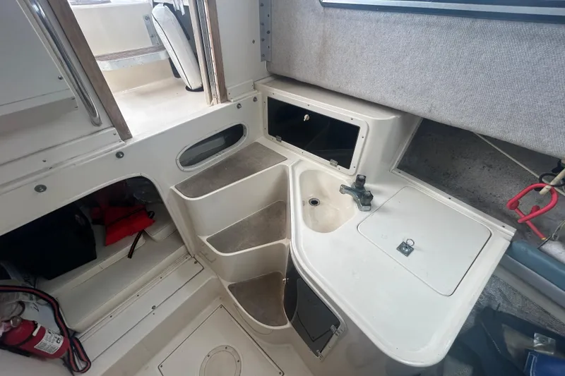 Slide: The Image of Interior of 1992 Grady-White Sailfish 252 boat with sink and storage compartments. - 14