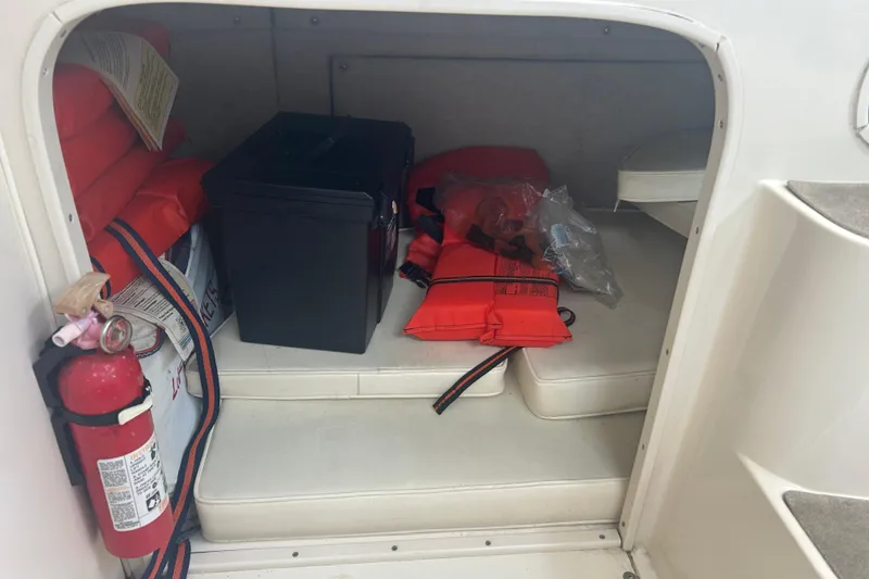 Slide: The Image of Storage area in 1992 Grady-White Sailfish 252 with life jackets and fire extinguisher. - 15