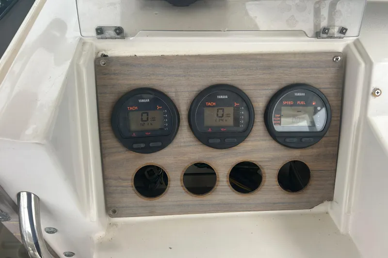 Slide: The Image of 1992 Grady-White Sailfish 252 dashboard with Yamaha gauges and empty slots. - 19