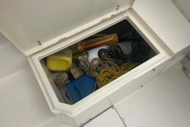 Slide: The Image of Storage compartment on a 1992 Grady-White Sailfish 252 boat with ropes and equipment. - 20