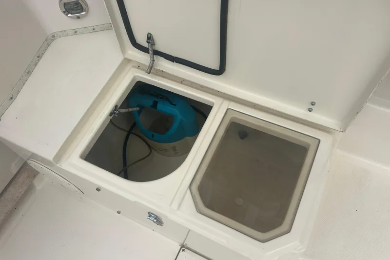 Slide: The Image of 1992 Grady-White Sailfish 252 boat compartment with storage and equipment. - 21