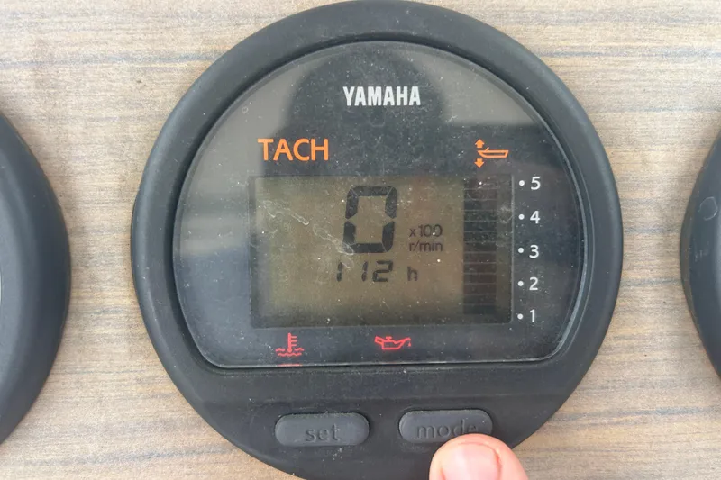 Slide: The Image of Yamaha tachometer displaying 112 hours on a 1992 Grady-White Sailfish 252 boat. - 23