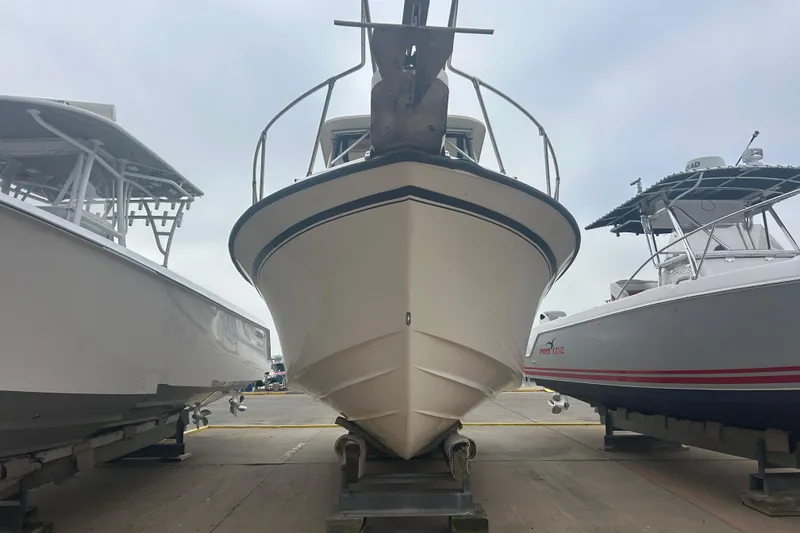 Slide: The Image of 1992 Grady-White Sailfish 252 boat on display between two other boats. - 3