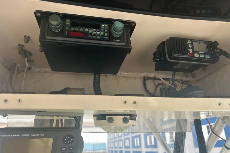 Slide: The Image of 1992 Grady-White Sailfish 252 boat dashboard with radio and GPS equipment. - 32