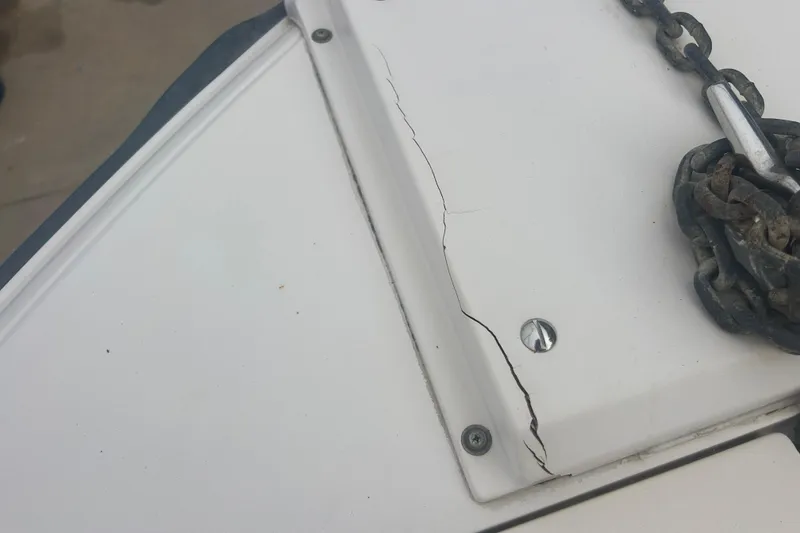 Slide: The Image of Cracked deck of 1992 Grady-White Sailfish 252 with chain and screws visible. - 34