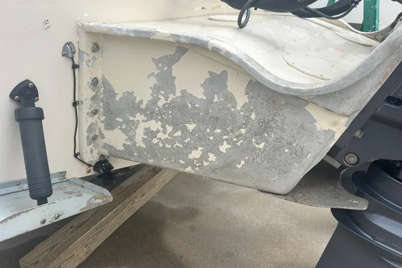 Slide: The Image of 1992 Grady-White Sailfish 252 boat with peeling paint on the transom. - 39