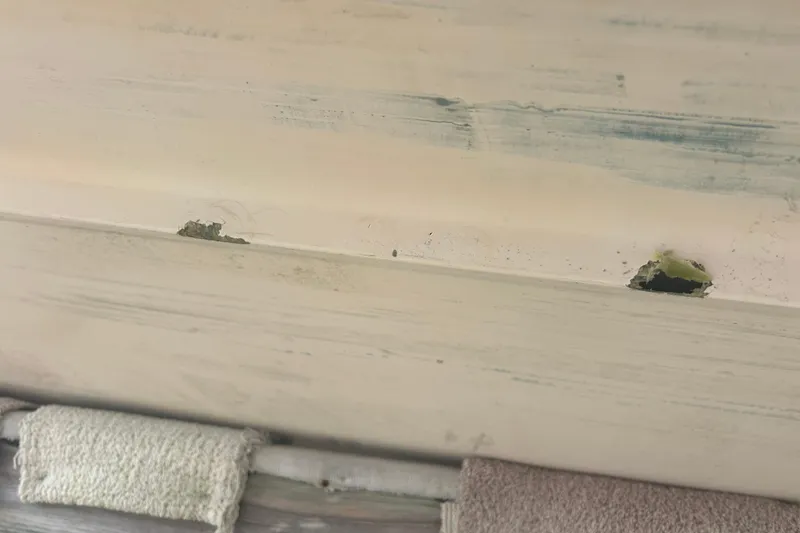 Slide: The Image of Damaged hull of 1992 Grady-White Sailfish 252 boat with visible holes and wear. - 41