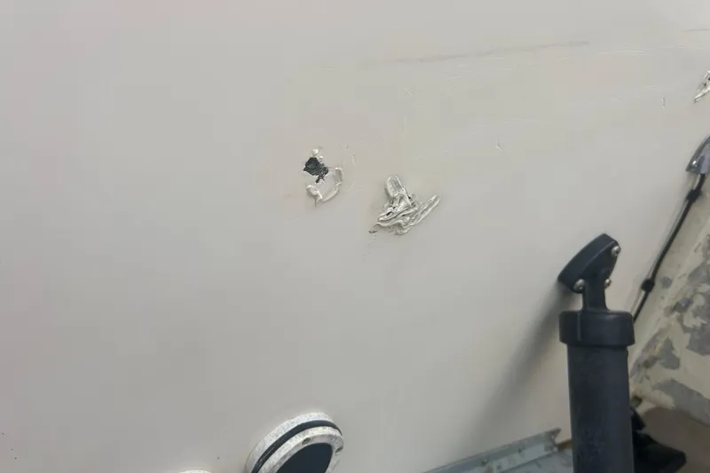 Slide: The Image of Close-up of damage on a 1992 Grady-White Sailfish 252 boat hull. - 43