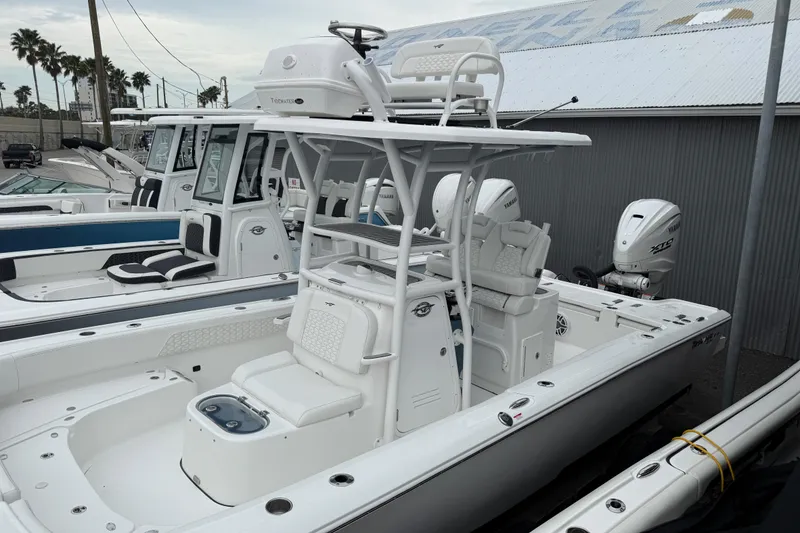 Slide: The Image of 2026 Tidewater 2700 Carolina Bay boat with dual Yamaha engines, docked in a marina. - 10