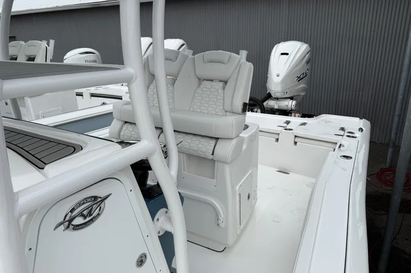 Slide: The Image of 2026 Tidewater 2700 Carolina Bay boat with dual Yamaha engines and cushioned seating. - 12
