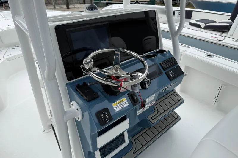 Slide: The Image of 2026 Tidewater 2700 Carolina Bay boat console with steering wheel and controls. - 15