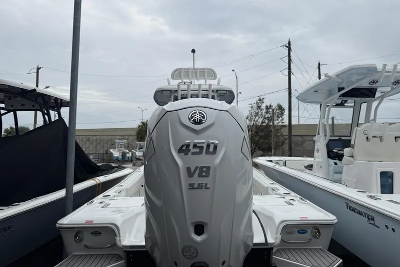 Slide: The Image of 2026 Tidewater 2700 Carolina Bay boat with powerful 450 V8 engine, docked outdoors. - 4
