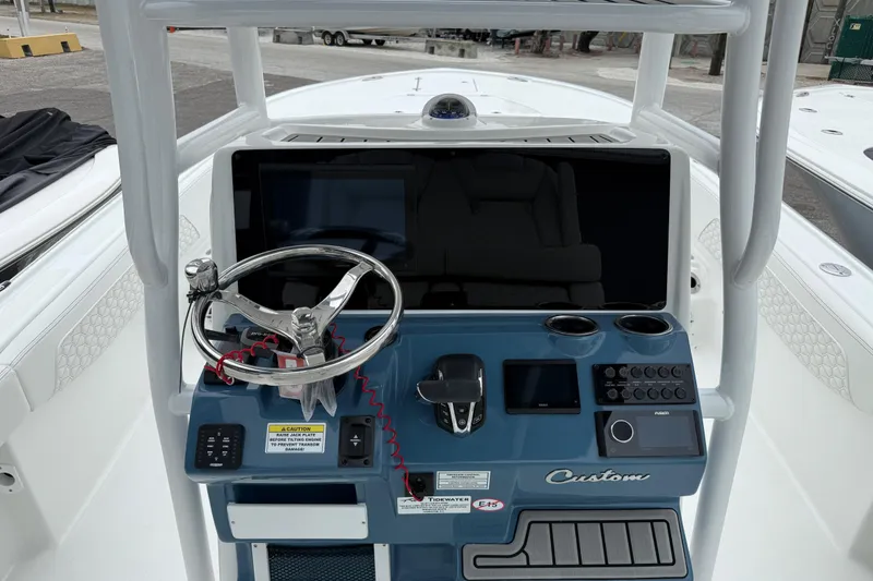 Slide: The Image of 2026 Tidewater 2700 Carolina Bay boat dashboard with steering wheel and control panel. - 7