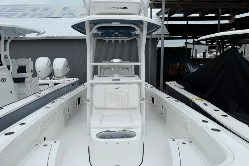 Slide: The Image of 2026 Tidewater 2700 Carolina Bay boat interior with seating and console, docked in marina. - 9