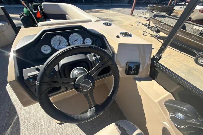 Slide: The Image of 2026 Bentley Pontoons Legacy 243 Navigator dashboard with steering wheel and gauges. - 11